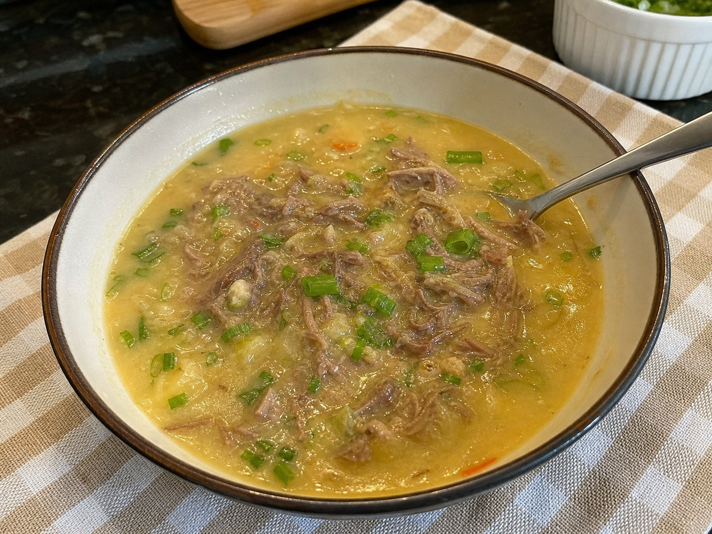 Caldo de mandioca cremoso com carne desfiada e cheiro-verde